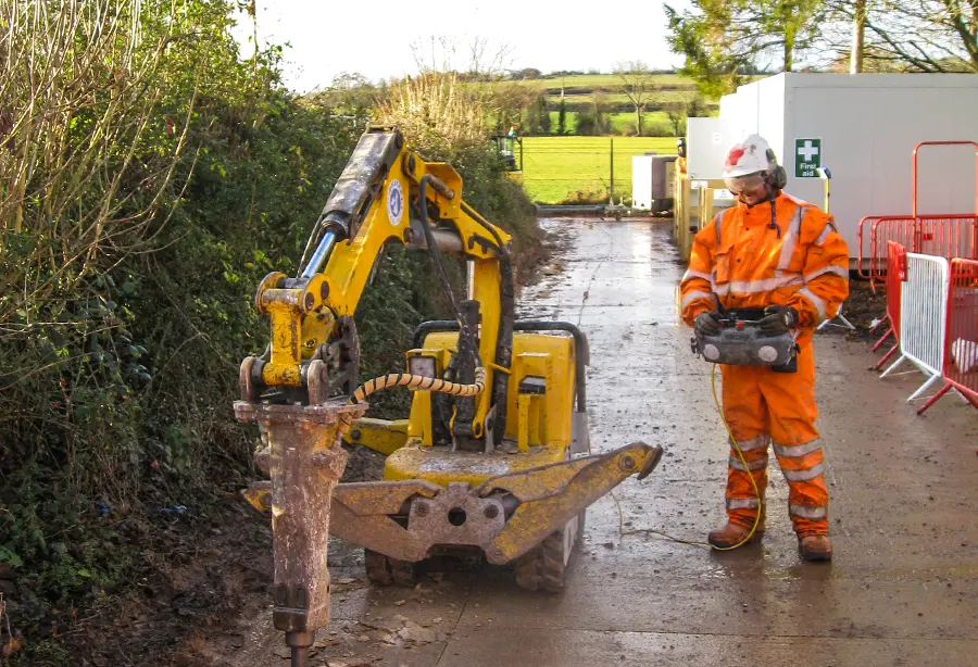 A Hayward operative in full PPE operating plant on a civil engineering site