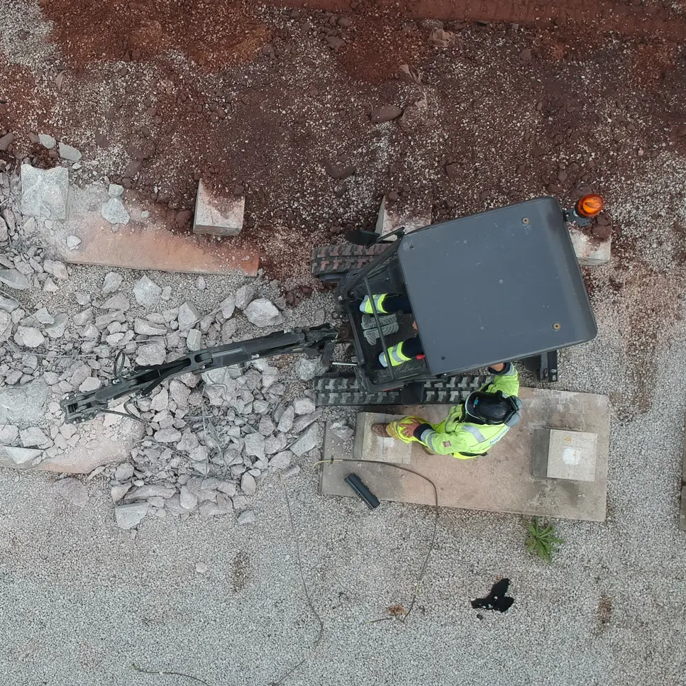 Hayward operatives using robotic demolition to break out reinforced concrete plinths on a live generation site